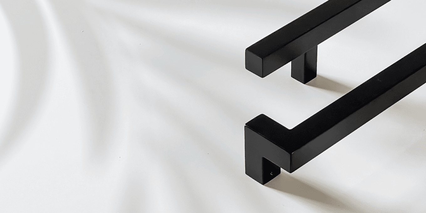 Matt black commercial pull handles on a white door